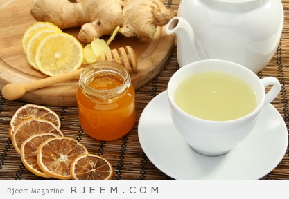 Ginger tea with honey and lemon on a bamboo napkin.